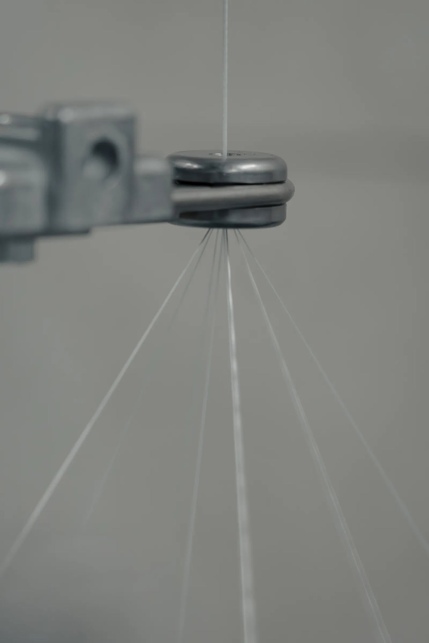 Fine braid strands converging into the braiding point of a Herzog machine